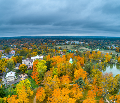 Aerial view of the historic Cesis Castle Park surrounded by vibrant autumn foliage lush trees and a serene pond in Cesis Cesis Municipality Latvia. Aerial view of the historic Cesis Castle Park surrounded by vibrant autumn foliage lush trees and a serene pond in Cesis Cesis Municipality Latvia.