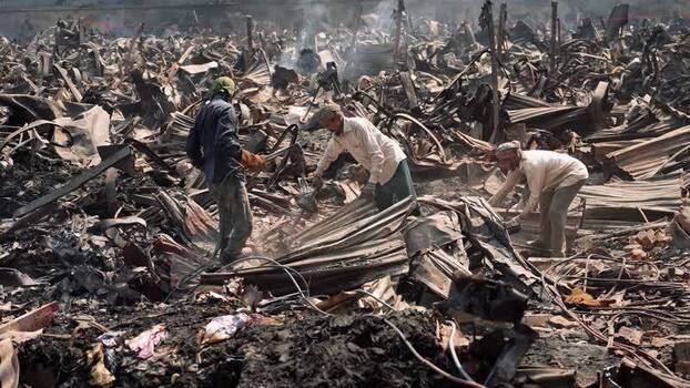 View of men clearing charred debris after a massive fire Bangladesh. View of men clearing charred debris after a massive fire Bangladesh.