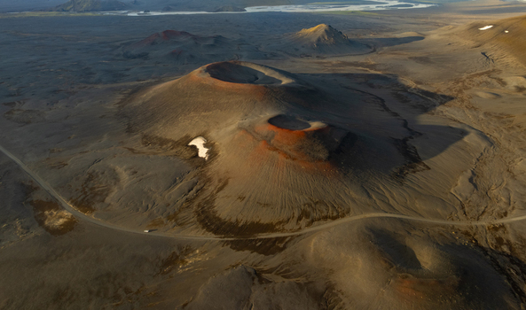 Aerial view of Landmannalaugar volcanic craters with rugged lava fields and winding gravel roads in Rangarthing ytra Iceland. Aerial view of Landmannalaugar volcanic craters with rugged lava fields and winding gravel roads in Rangarthing ytra Iceland.