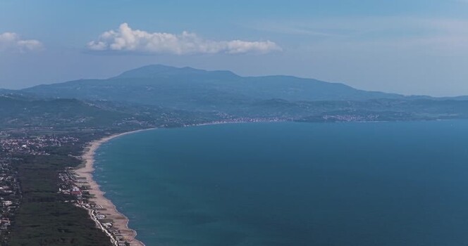 Aerial view of the sandy coastline and blue sea Italy.