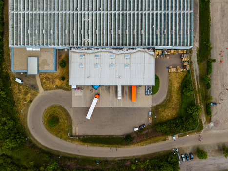 Aerial view of Serways Raststatte Hohenlohe Sud showing semi trucks parked at the loading docks asphalt parking area and surrounding greenery in Neuenstein Baden Wurttemberg Germany. Aerial view of Serways Raststatte Hohenlohe Sud showing semi trucks parked at the loading docks asphalt parking area and surrounding greenery in Neuenstein Baden Wurttemberg Germany.
