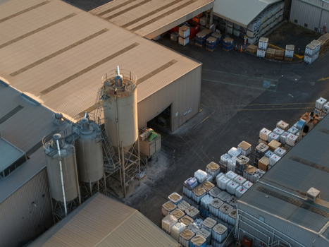 Melbourne Australia 22 September 2026 Aerial view of industrial factories in Kilsyth with large storage silos rows of plastic containers and metal roofed warehouse buildings. Melbourne Australia 22 September 2026 Aerial view of industrial factories in Kilsyth with large storage silos rows of plastic containers and metal roofed warehouse buildings.