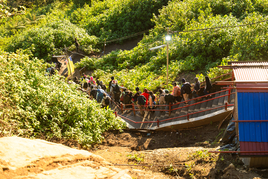 View of pilgrims climbing the steep stairs of Adam s Peak surrounded by lush green vegetation under bright sunlight in Ratnapura Sabaragamuwa Province Sri Lanka. View of pilgrims climbing the steep stairs of Adam s Peak surrounded by lush green vegetation under bright sunlight in Ratnapura Sabaragamuwa Province Sri Lanka.