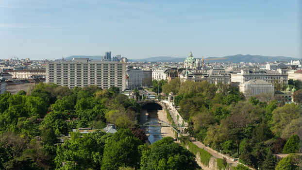 Aerial view of the lush Stadtpark with the Wien River flowing through it historic architecture including the Karlskirche dome and the city skyline under a clear blue sky in Vienna Vienna Austria. Aerial view of the lush Stadtpark with the Wien River flowing through it historic architecture including the Karlskirche dome and the city skyline under a clear blue sky in Vienna Vienna Austria.