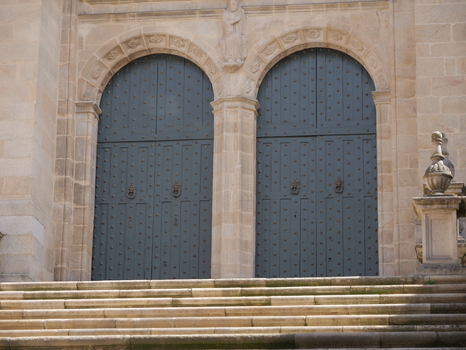 View of the ornate stone entrance and dark studded wooden doors of the Catedral de Ourense Ourense Ourense Spain. View of the ornate stone entrance and dark studded wooden doors of the Catedral de Ourense Ourense Ourense Spain.