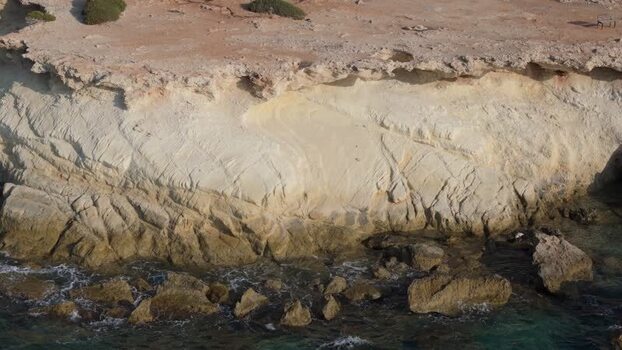 Aerial view of coastal cliffs and rocky shoreline in Cyprus.