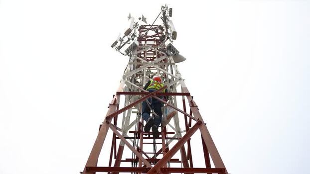 View of a technician climbing a telecommunications tower Bangladesh.