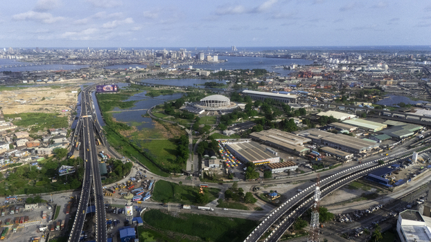 Aerial view of the Wole Soyinka Centre for Culture and Creative Arts National Theatre Nigeria surrounded by highways and the city skyline in Lagos Lagos Nigeria. Aerial view of the Wole Soyinka Centre for Culture and Creative Arts National Theatre Nigeria surrounded by highways and the city skyline in Lagos Lagos Nigeria.