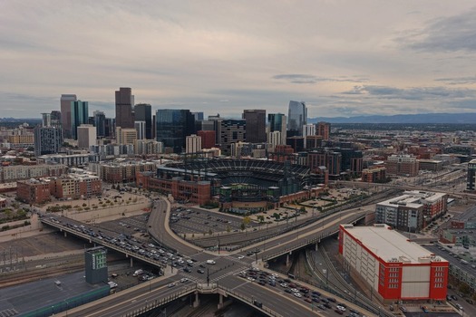Denver United States 29 September 2026 Aerial view of Coors Field and the surrounding Denver skyline with urban infrastructure highways and modern buildings under a cloudy sky. Denver United States 29 September 2026 Aerial view of Coors Field and the surrounding Denver skyline with urban infrastructure highways and modern buildings under a cloudy sky.