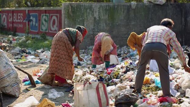 View of people scavenging through a garbage dump Bangladesh. View of people scavenging through a garbage dump Bangladesh.