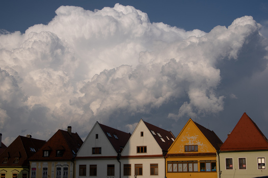 Aerial view of historic colorful houses with gabled roofs under massive dramatic white clouds in Bardejov Presov Region Slovakia. Aerial view of historic colorful houses with gabled roofs under massive dramatic white clouds in Bardejov Presov Region Slovakia.