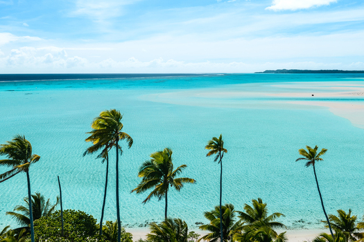 Aerial view of Aitutaki lagoon with turquoise water white sandy beaches and lush palm trees in Cook Islands. Aerial view of Aitutaki lagoon with turquoise water white sandy beaches and lush palm trees in Cook Islands.