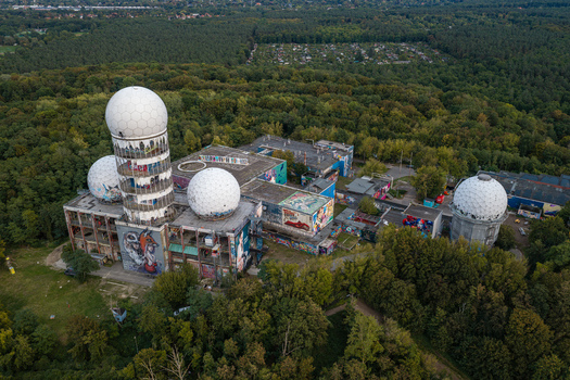 Aerial view of the abandoned Teufelsberg NSA Station with its iconic white radar domes covered in graffiti surrounded by the dense Grunewald forest in Berlin Berlin Germany.