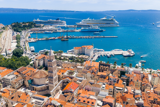 Aerial view of the Cathedral of Saint Domnius and historic rooftops overlooking the harbor with large cruise ships in Split Split Dalmatia County Croatia. Aerial view of the Cathedral of Saint Domnius and historic rooftops overlooking the harbor with large cruise ships in Split Split Dalmatia County Croatia.