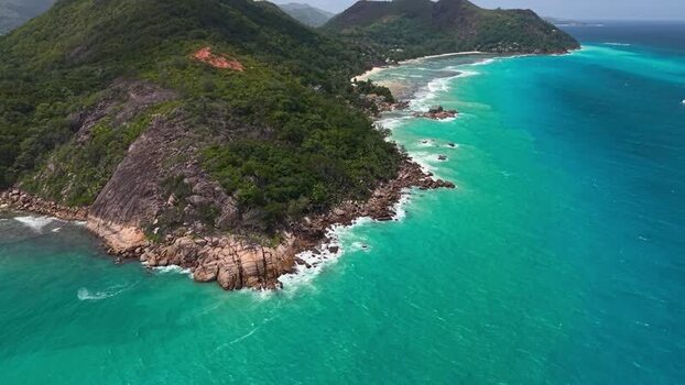 Aerial view of the lush coastline and turquoise waters Seychelles.