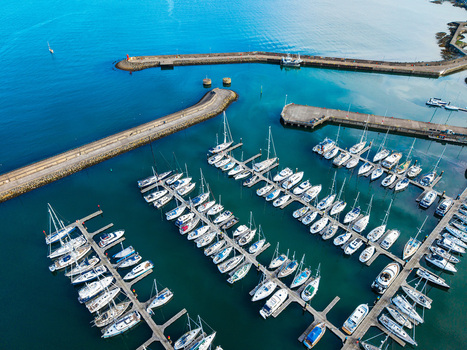 Aerial view of Bangor Harbour and Town featuring sailboats and yachts docked in the marina surrounded by stone breakwaters in Bangor Northern Ireland United Kingdom.