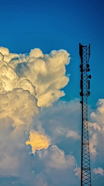 View of telecommunications tower against dramatic clouds in Latvia. View of telecommunications tower against dramatic clouds in Latvia.