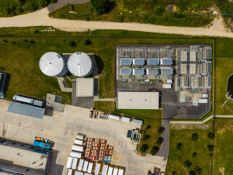 Aerial view of an industrial facility with large storage tanks rectangular buildings and a paved yard Zebrak Central Bohemian Region Czechia. Aerial view of an industrial facility with large storage tanks rectangular buildings and a paved yard Zebrak Central Bohemian Region Czechia.