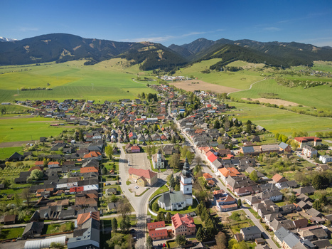 Aerial view of the historic village of Partizanska Lupca with its church tower traditional houses and surrounding green hills in Partizanska Lupca Zilina Region Slovakia. Aerial view of the historic village of Partizanska Lupca with its church tower traditional houses and surrounding green hills in Partizanska Lupca Zilina Region Slovakia.