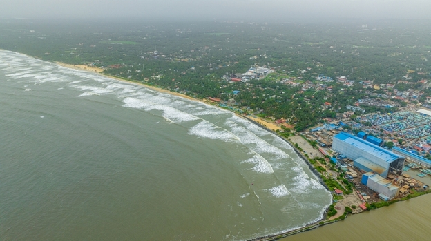 Aerial view of Malpe Fishing Harbour with its industrial buildings fishing boats docked in the harbor and the sandy coastline meeting the Arabian Sea Udupi Karnataka India. Aerial view of Malpe Fishing Harbour with its industrial buildings fishing boats docked in the harbor and the sandy coastline meeting the Arabian Sea Udupi Karnataka India.