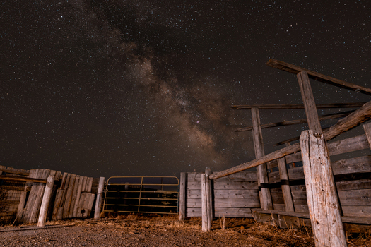 View of the old wooden corral under the brilliant Milky Way core in the night sky in Picabo Idaho United States.