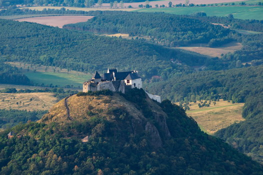 Aerial view of Fuzer Castle perched on a volcanic hill surrounded by lush green forests and rolling hills in Fuzer Borsod Abauj Zemplen Hungary. Aerial view of Fuzer Castle perched on a volcanic hill surrounded by lush green forests and rolling hills in Fuzer Borsod Abauj Zemplen Hungary.