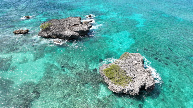 Aerial view of rocky outcrops surrounded by clear turquoise Caribbean sea waters near the coast of Rio San Juan Maria Trinidad Sanchez Dominican Republic.