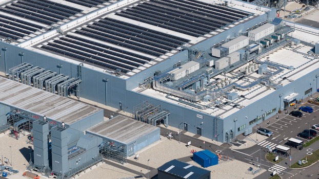 Aerial view of the HGB industrial facility featuring extensive rooftop solar panels modern HVAC systems and a parking lot in Winschoten Groningen Netherlands.