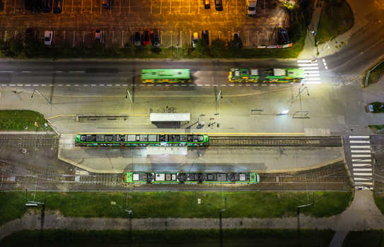 Aerial view of Jana III Sobieskiego Bus and Tram Terminal at night with illuminated green trams and buses at the station in Poznan Greater Poland Voivod Poland. Aerial view of Jana III Sobieskiego Bus and Tram Terminal at night with illuminated green trams and buses at the station in Poznan Greater Poland Voivod Poland.