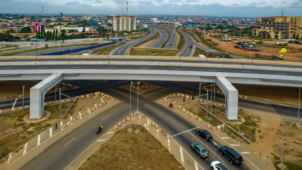 Aerial view of the Tema Motorway interchange featuring multi level highway infrastructure with flowing traffic and urban surroundings in Accra Greater Accra Region Ghana. Aerial view of the Tema Motorway interchange featuring multi level highway infrastructure with flowing traffic and urban surroundings in Accra Greater Accra Region Ghana.