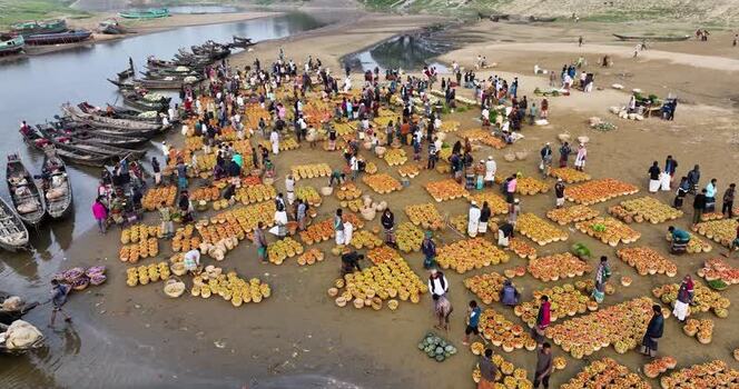 Aerial view of a busy riverside fruit market Bangladesh.