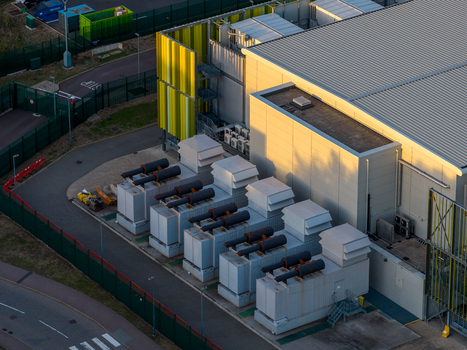 Aerial view of Kao Data facility featuring rows of industrial cooling units and modern infrastructure in Harlow England United Kingdom. Aerial view of Kao Data facility featuring rows of industrial cooling units and modern infrastructure in Harlow England United Kingdom.