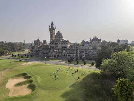 Vadodara India 14 March 2026 Aerial view of Laxmi Vilas Palace with its intricate Indo Saracenic architecture surrounded by a green golf course with people playing and lush trees. Vadodara India 14 March 2026 Aerial view of Laxmi Vilas Palace with its intricate Indo Saracenic architecture surrounded by a green golf course with people playing and lush trees.
