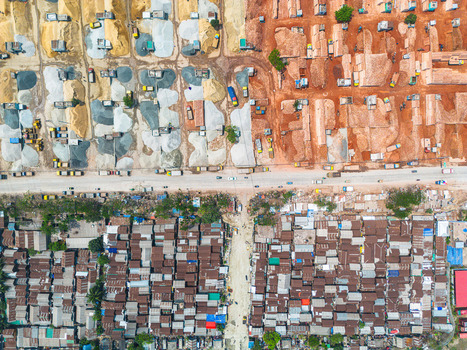 Aerial view of contrasting textures of raw materials vibrant red soil and clustered rooftops create a compelling tapestry Dhaka Dhaka Division Bangladesh. Aerial view of contrasting textures of raw materials vibrant red soil and clustered rooftops create a compelling tapestry Dhaka Dhaka Division Bangladesh.