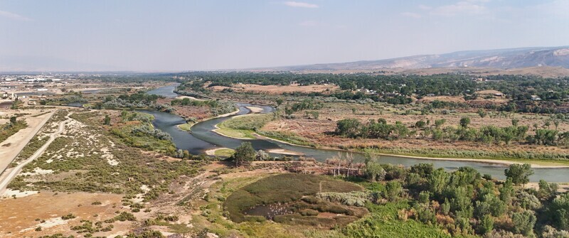 Aerial view of the Colorado River showing low water levels and smokey haze during a severe drought near Grand Junction Colorado United States. Aerial view of the Colorado River showing low water levels and smokey haze during a severe drought near Grand Junction Colorado United States.