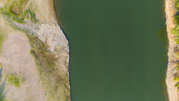 Aerial view of the Po River showing low water levels and exposed riverbed sediments due to summer drought in Castelvetro Piacentino Emilia Romagna Italy. Aerial view of the Po River showing low water levels and exposed riverbed sediments due to summer drought in Castelvetro Piacentino Emilia Romagna Italy.
