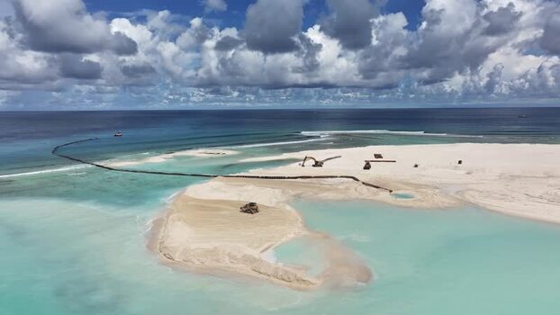 Aerial view of land reclamation with excavators on white sand Maldives. Aerial view of land reclamation with excavators on white sand Maldives.