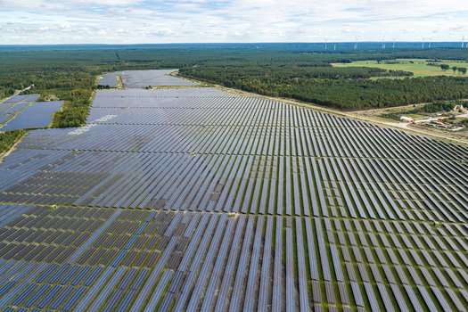 Aerial view of the solar field at the former military airfield in Preschen with rows of solar panels historic hangars and runway remnants in Neisse Malxetal Brandenburg Germany. Aerial view of the solar field at the former military airfield in Preschen with rows of solar panels historic hangars and runway remnants in Neisse Malxetal Brandenburg Germany.
