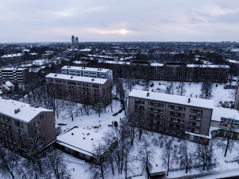 Aerial view of the Agenskalna priedes neighborhood with apartment blocks and snow covered trees under a winter sky in Riga Latvia. Aerial view of the Agenskalna priedes neighborhood with apartment blocks and snow covered trees under a winter sky in Riga Latvia.