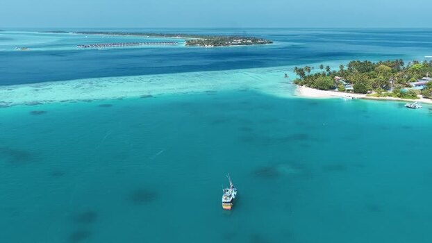 Aerial view of a Sri Lankan boat in turquoise waters near Kudahuvadhoo Maldives. Aerial view of a Sri Lankan boat in turquoise waters near Kudahuvadhoo Maldives.