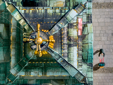 Aerial view of the ornate green and gold roof of a historic building in Belgrade with a person pulling a cart on the stone pavement below Belgrade City of Belgrade Serbia. Aerial view of the ornate green and gold roof of a historic building in Belgrade with a person pulling a cart on the stone pavement below Belgrade City of Belgrade Serbia.