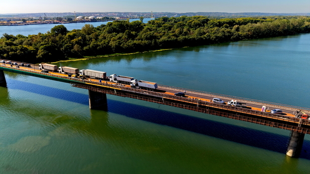Aerial view of the Smederevo bridge crossing the Danube river with trucks and cars near the industrial shipyard in Smederevo Podunavlje District Serbia.