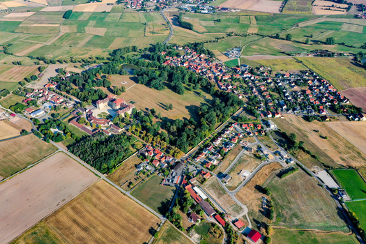 Aerial view of Schloss Weissenstein baroque palace surrounded by lush parkland and rural fields in Pommersfelden Bavaria Germany. Aerial view of Schloss Weissenstein baroque palace surrounded by lush parkland and rural fields in Pommersfelden Bavaria Germany.