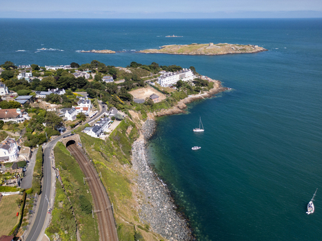 Aerial view of the Dalkey coastline featuring the railway tunnel coastal houses and Dalkey Island in the Irish Sea Dublin County Dublin Ireland. Aerial view of the Dalkey coastline featuring the railway tunnel coastal houses and Dalkey Island in the Irish Sea Dublin County Dublin Ireland.