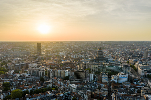 Aerial view of the Brussels cityscape at sunset featuring the Palais de Justice dense urban architecture and a ferris wheel under a warm golden sky. Brussels Brussels Belgium. Aerial view of the Brussels cityscape at sunset featuring the Palais de Justice dense urban architecture and a ferris wheel under a warm golden sky. Brussels Brussels Belgium.