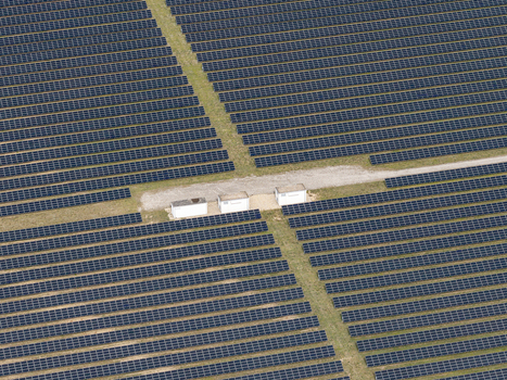 Aerial view of the solar farm at the former Preschen military airfield featuring rows of photovoltaic panels and small utility buildings in Neisse Malxetal Brandenburg Germany. Aerial view of the solar farm at the former Preschen military airfield featuring rows of photovoltaic panels and small utility buildings in Neisse Malxetal Brandenburg Germany.