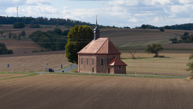 Aerial view of the historic Wendelinuskapelle chapel surrounded by rural agricultural fields and a quiet road in Dieburg Hessen Germany. Aerial view of the historic Wendelinuskapelle chapel surrounded by rural agricultural fields and a quiet road in Dieburg Hessen Germany.