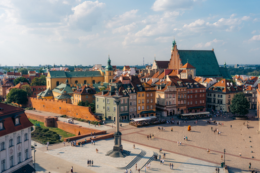View of Warsaw Old Town featuring Sigismund s Column in Castle Square surrounded by historic colorful buildings and medieval fortifications under a blue sky. Warsaw Masovian Voivodeship Poland. View of Warsaw Old Town featuring Sigismund s Column in Castle Square surrounded by historic colorful buildings and medieval fortifications under a blue sky. Warsaw Masovian Voivodeship Poland.