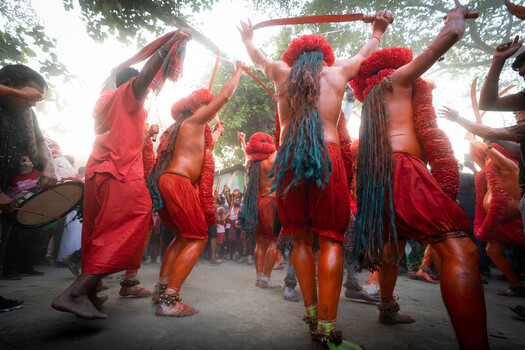 Munshiganj Bangladesh 13 April 2025 View of fiery red and orange clad performers with flowing hair energetically dance raising swords in a vibrant rhythmic display. Munshiganj Bangladesh 13 April 2025 View of fiery red and orange clad performers with flowing hair energetically dance raising swords in a vibrant rhythmic display.