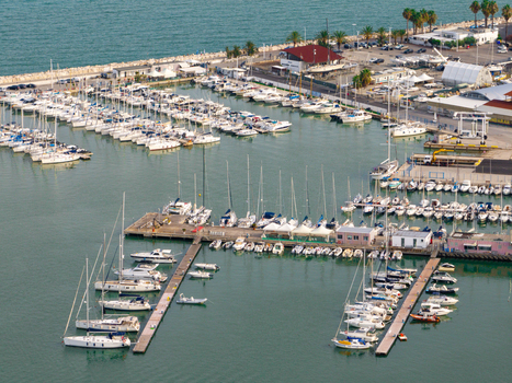 Aerial view of the marina featuring numerous sailboats and yachts docked at piers with the port authorities building near the waterfront in San Benedetto del Tronto Marche Italy. Aerial view of the marina featuring numerous sailboats and yachts docked at piers with the port authorities building near the waterfront in San Benedetto del Tronto Marche Italy.